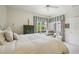 Light-filled bedroom featuring a reading chair, and access to the backyard at 1831 San Silvestro Dr, Venice, FL 34285