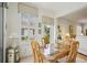 Cozy dining area featuring a glass table, wood chairs, tile floors, and plenty of natural light at 1831 San Silvestro Dr, Venice, FL 34285