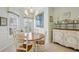 Comfortable dining area features a round table, stylish chandelier, and a built-in cabinet at 1831 San Silvestro Dr, Venice, FL 34285