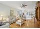 Comfortable living room with hardwood floors, neutral colors, ceiling fan, and backyard access at 1831 San Silvestro Dr, Venice, FL 34285