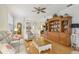 Open living room with hardwood floors, ceiling fan, built-in shelves, and lots of natural light at 1831 San Silvestro Dr, Venice, FL 34285