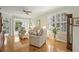 Bright living room with hardwood floors, neutral walls, and plantation shutters at 1831 San Silvestro Dr, Venice, FL 34285