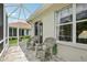 An inviting screened-in patio features stylish wicker chairs and sun protection for outdoor relaxation at 1831 San Silvestro Dr, Venice, FL 34285