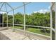 Serene patio view showcasing lush greenery and a well-maintained yard, offering a peaceful outdoor living space at 1831 San Silvestro Dr, Venice, FL 34285