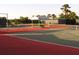 Well-maintained tennis court with a shaded bench, ready for a friendly match in a scenic setting at 1831 San Silvestro Dr, Venice, FL 34285