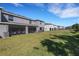 A spacious backyard featuring a well-maintained lawn and screened-in patio area at 1860 Pleasant Maple Ct, Bradenton, FL 34211