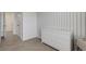 Bedroom features striped wallpaper, white dresser, and changing table at 1860 Pleasant Maple Ct, Bradenton, FL 34211