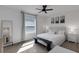 Bright bedroom with carpet, ceiling fan, large window, and comfortable queen bed with bench seating at 1860 Pleasant Maple Ct, Bradenton, FL 34211