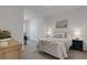 Well-lit bedroom featuring a comfortable bed, nightstands, and decorative artwork at 1860 Pleasant Maple Ct, Bradenton, FL 34211
