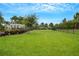 Spacious fenced dog park with lush grass and shade trees, perfect for furry friends at 1860 Pleasant Maple Ct, Bradenton, FL 34211