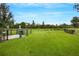 Fenced community dog park with lush grass and pet waste station for convenience at 1860 Pleasant Maple Ct, Bradenton, FL 34211