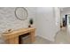 Bright entryway with white walls, patterned wallpaper, round mirror, and decorative console table at 1860 Pleasant Maple Ct, Bradenton, FL 34211
