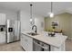 Bright kitchen with stainless steel appliances and center island with pendant lighting at 1860 Pleasant Maple Ct, Bradenton, FL 34211