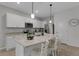 Well-lit kitchen featuring stainless steel appliances and a large island with breakfast bar at 1860 Pleasant Maple Ct, Bradenton, FL 34211