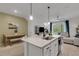 Open-concept kitchen features center island, stainless appliances, and adjacent living area at 1860 Pleasant Maple Ct, Bradenton, FL 34211