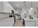 Modern kitchen with stainless steel appliances, center island, and ample counter space at 1860 Pleasant Maple Ct, Bradenton, FL 34211