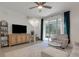 Cozy living room with neutral decor, TV, stairs, and sliding glass door leading to the outdoor space at 1860 Pleasant Maple Ct, Bradenton, FL 34211