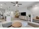Open-concept living room with tile flooring, ceiling fan, and modern furnishings adjacent to kitchen and dining area at 1860 Pleasant Maple Ct, Bradenton, FL 34211