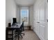 Bright office features a window with blinds, a dark wood desk, and storage at 1860 Pleasant Maple Ct, Bradenton, FL 34211