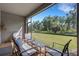 Enclosed patio with modern furniture and views of lush greenery at 1860 Pleasant Maple Ct, Bradenton, FL 34211