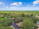 An aerial view reveals the property's location in a lush, tree-filled neighborhood at 1930 Peppermill Dr, Clearwater, FL 33763