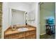 Bathroom featuring a wood vanity, mirror, and a mosaic tile shower at 1930 Peppermill Dr, Clearwater, FL 33763