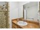 Bathroom featuring a shower and wood vanity with sink at 1930 Peppermill Dr, Clearwater, FL 33763