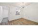 The dining room has wood floors and a modern chandelier at 1930 Peppermill Dr, Clearwater, FL 33763