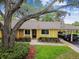 Charming single-story home featuring a carport and a walkway leading to the front door at 1930 Peppermill Dr, Clearwater, FL 33763