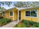 Charming home with a black front door, accented by updated windows and well-maintained landscaping at 1930 Peppermill Dr, Clearwater, FL 33763
