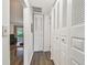 Hallway with wooden floors leading to a living room at 1930 Peppermill Dr, Clearwater, FL 33763