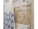 Shower featuring neutral tile at 1930 Peppermill Dr, Clearwater, FL 33763