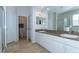 Bathroom features dual sinks, a large mirror, and a separate shower, designed for comfort and convenience at 2160 Brandon Park Cir, Brandon, FL 33510
