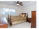 Bedroom with a ceiling fan, window with blinds, and a patterned bedspread at 2160 Brandon Park Cir, Brandon, FL 33510