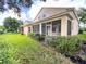 Lovely exterior view of the home with screened-in porch, lush lawn, and manicured hedges at 2160 Brandon Park Cir, Brandon, FL 33510