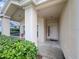 Inviting front entry featuring a covered porch and well-manicured landscaping at 2160 Brandon Park Cir, Brandon, FL 33510