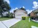 Beautiful single-Gathering home with manicured lawn, mature landscaping, and a two-car garage at 2160 Brandon Park Cir, Brandon, FL 33510