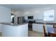 Open kitchen layout with stainless steel appliances, sleek white cabinetry, and a counter that seats two at 2160 Brandon Park Cir, Brandon, FL 33510