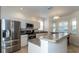 Modern kitchen with stainless steel appliances, white cabinets, and a breakfast bar overlooking the dining area at 2160 Brandon Park Cir, Brandon, FL 33510