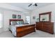 Comfortable main bedroom with a wood sleigh bed, a dresser with mirror, and soft neutral tones at 2160 Brandon Park Cir, Brandon, FL 33510