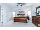 Cozy main bedroom with a wood sleigh bed, ceiling fan, and private access to an outdoor space at 2160 Brandon Park Cir, Brandon, FL 33510