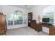 Bright home office with natural light, a large desk, and built-in bookshelves for storage at 2160 Brandon Park Cir, Brandon, FL 33510