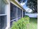 This screened porch with chairs and view is perfect for relaxing and enjoying the outdoors at 2160 Brandon Park Cir, Brandon, FL 33510