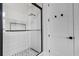 Modern bathroom features a glass shower with rain shower head, pebble floor and sleek hardware at 2182 Wisteria St, Sarasota, FL 34239
