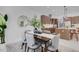Modern dining area with table, comfortable chairs, and an adjacent gourmet kitchen at 2182 Wisteria St, Sarasota, FL 34239