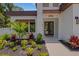 Covered front entryway with stone accents and decorative foliage at 2182 Wisteria St, Sarasota, FL 34239