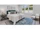Calm main bedroom features a stylish bed, decorative rug, and plenty of natural light at 2182 Wisteria St, Sarasota, FL 34239
