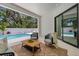 An outdoor patio area with comfortable seating, a coffee table, and views of the pool at 2182 Wisteria St, Sarasota, FL 34239