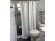 Bright bathroom featuring a shower with mosaic tile and a blue and white shower curtain at 2218 Orange Blossom Ln # 0, Bradenton, FL 34207