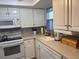 Galley kitchen with white cabinets and counters and stainless steel appliances at 2218 Orange Blossom Ln # 0, Bradenton, FL 34207